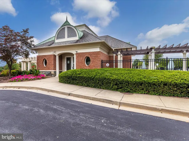 a kitchen with a table chairs refrigerator and microwave