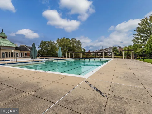 a spacious bedroom with a bed and wooden floor