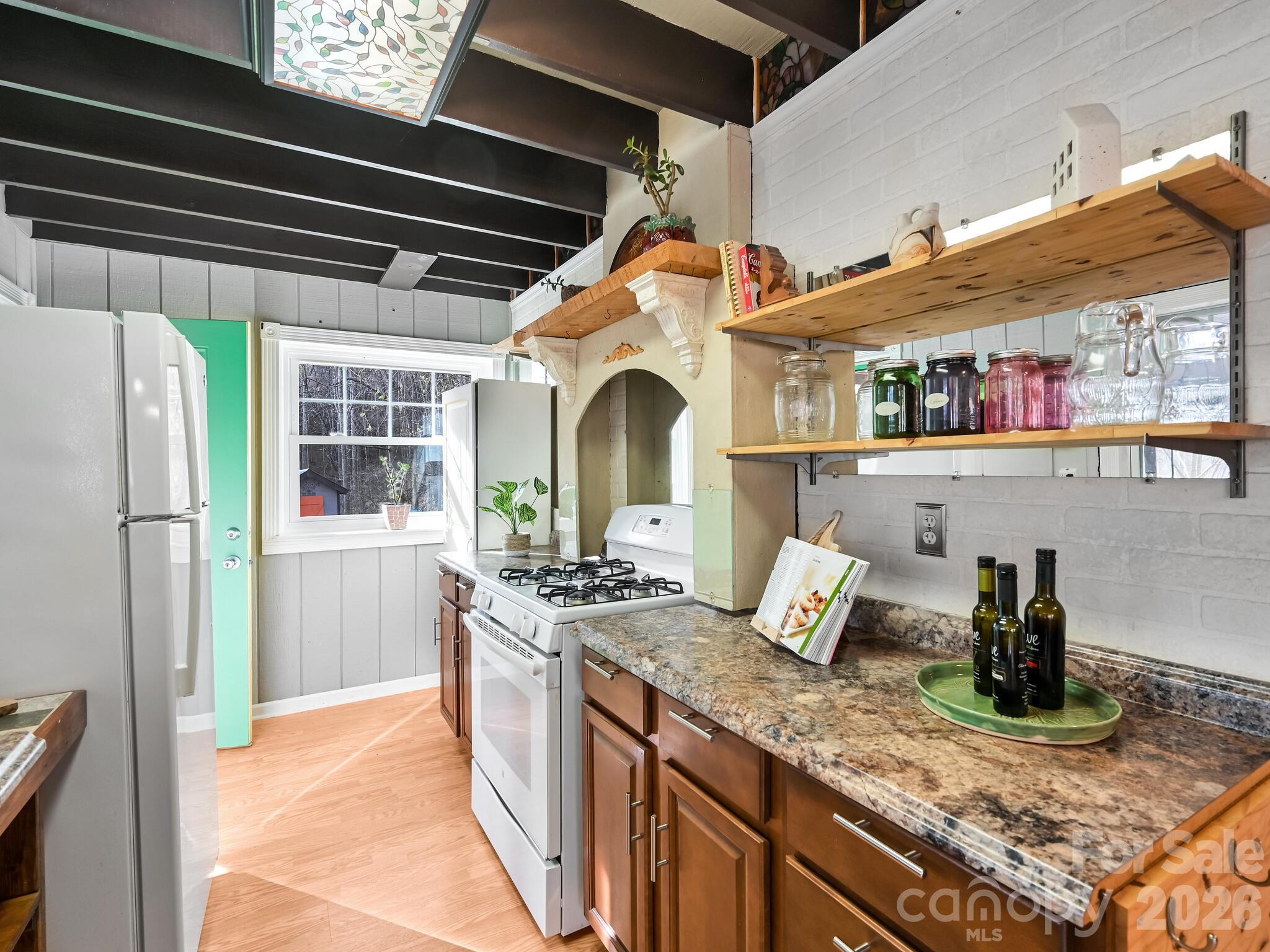90 Davidson Gap Road Leicester, NC 28748 - Photo 11 of 46 a kitchen with stainless steel appliances granite countertop a sink and a stove