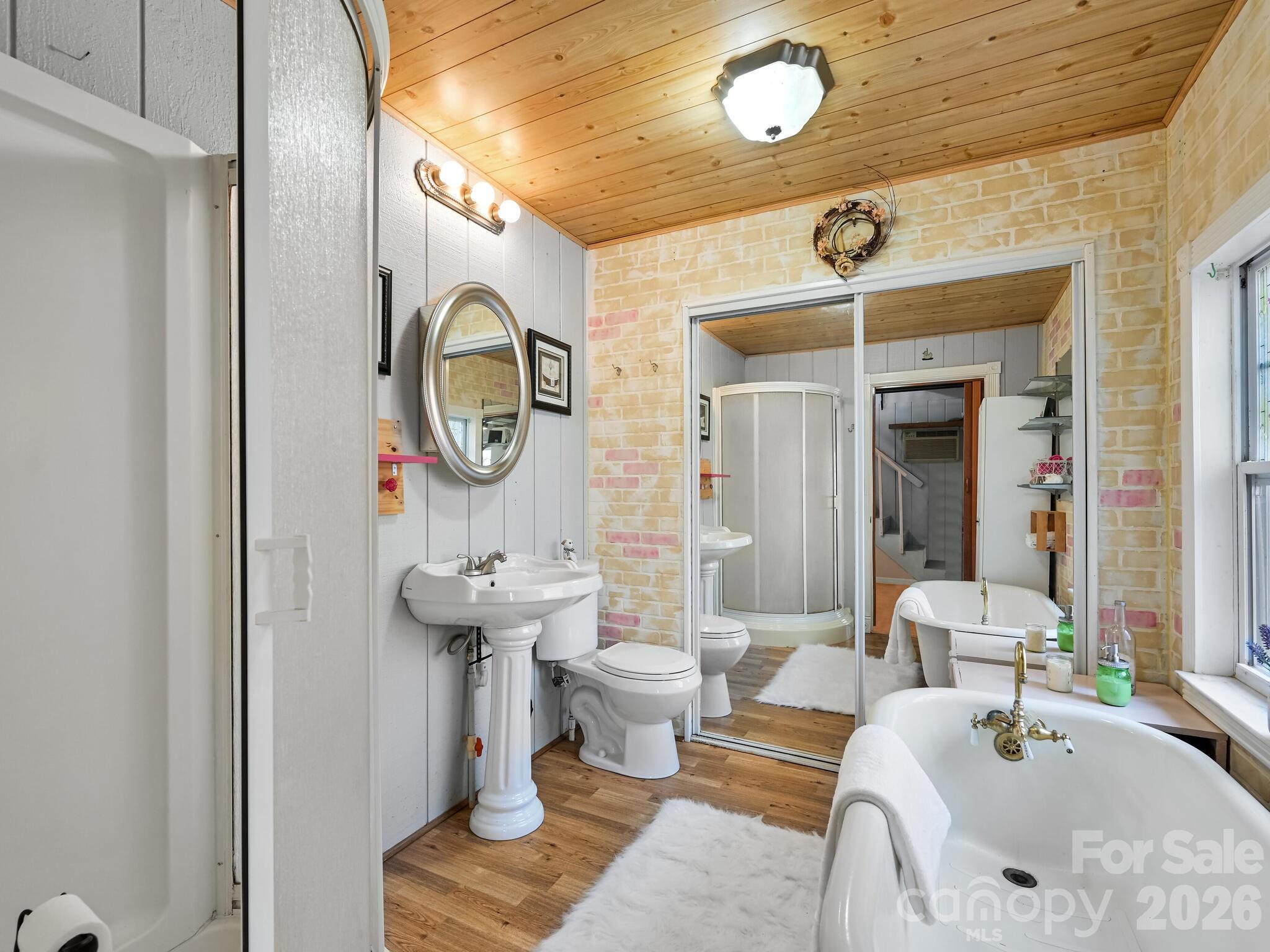 90 Davidson Gap Road Leicester, NC 28748 - Photo 15 of 46 a bathroom with a toilet a sink and a mirror