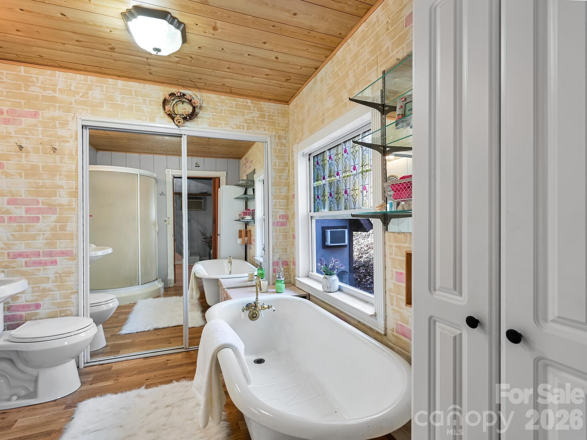 90 Davidson Gap Road Leicester, NC 28748 - Photo 16 of 46 a bathroom with a sink a toilet and shower