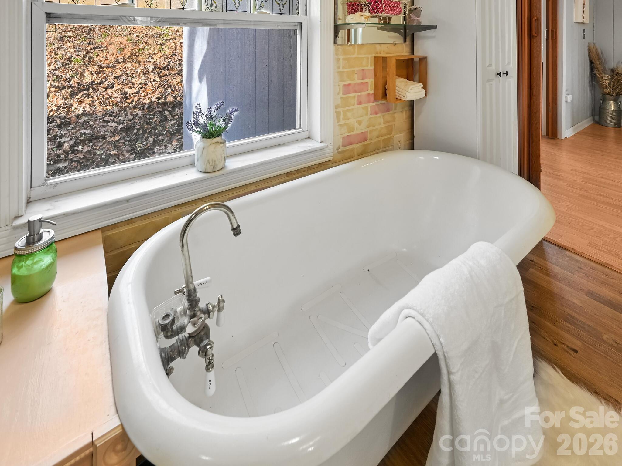 90 Davidson Gap Road Leicester, NC 28748 - Photo 17 of 46 a bath tub sitting in a bathroom next to a window