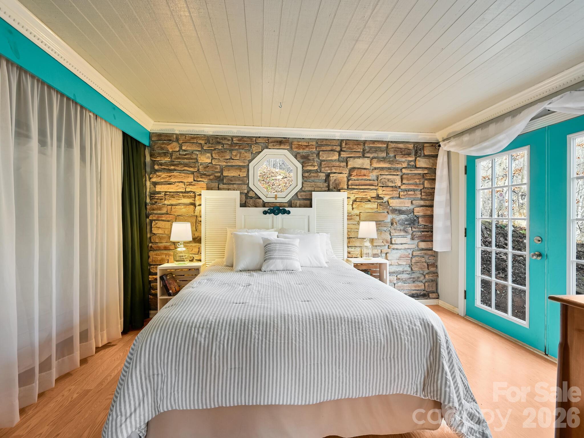 90 Davidson Gap Road Leicester, NC 28748 - Photo 19 of 46 a bedroom with a large bed and a large window