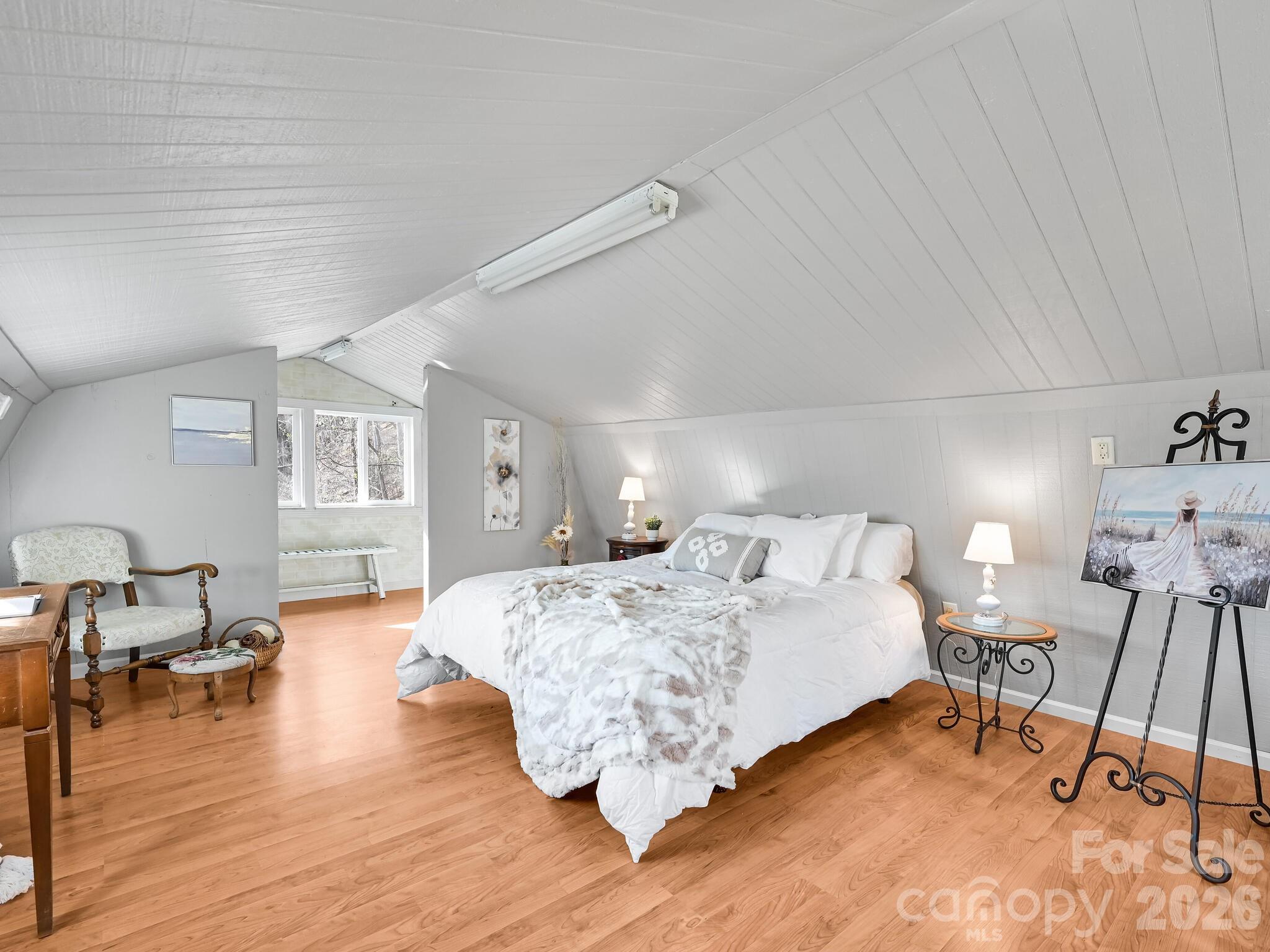 90 Davidson Gap Road Leicester, NC 28748 - Photo 22 of 46 a bed room with a bed and a chair