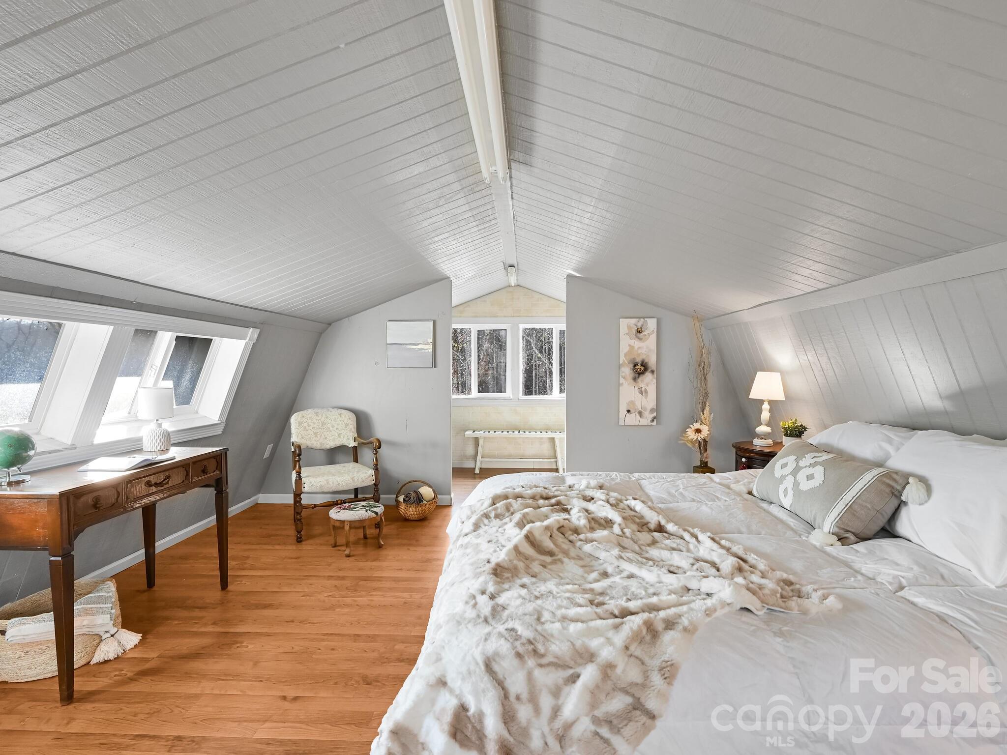 90 Davidson Gap Road Leicester, NC 28748 - Photo 23 of 46 a bedroom with a bed and wooden floor