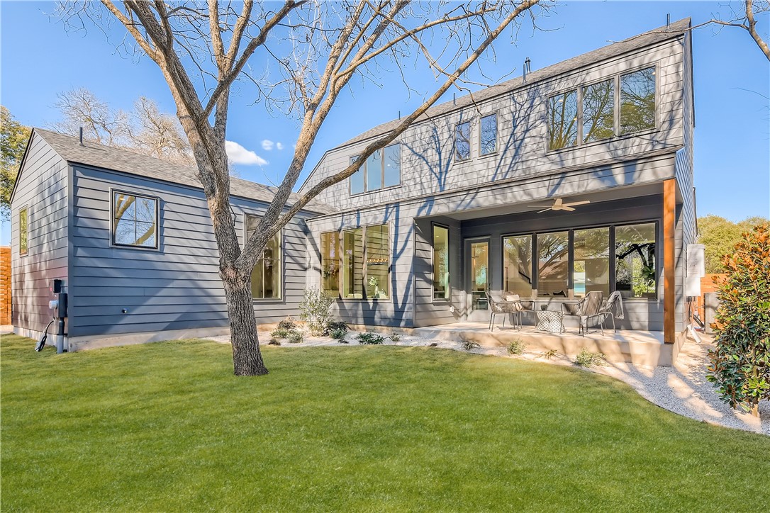 a view of a house with backyard porch and sitting area
