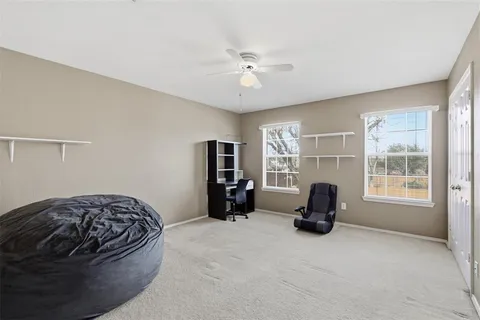 a bedroom with a bed and a large window