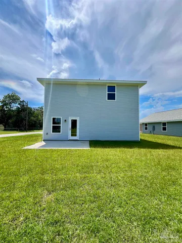 a backyard of a house with lots of green space and garden view
