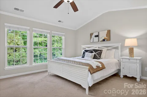 a bed sitting in a bedroom next to a window