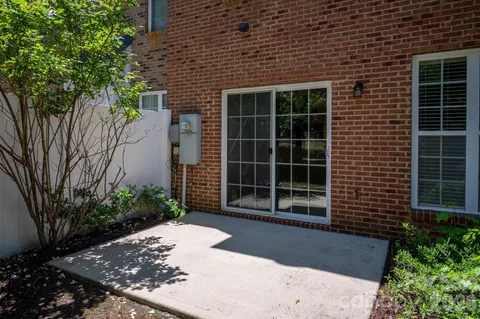 a front view of a house with a yard and potted plants