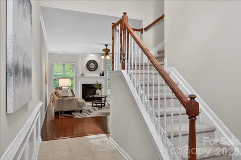 a view of a livingroom with wooden floor and staircase