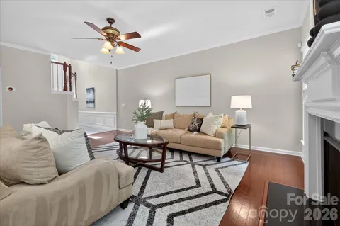 a living room with furniture a fireplace and a chandelier