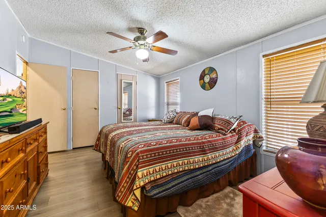 a bedroom with a bed and a chandelier