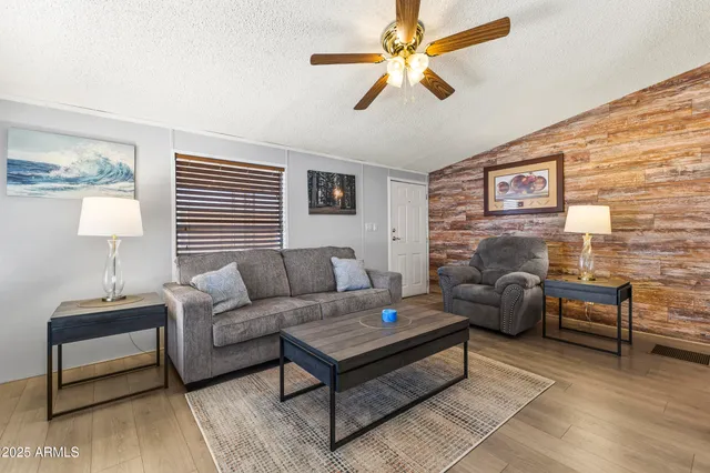 a living room with furniture a rug and a window
