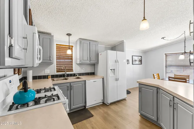 a kitchen with a sink stove and refrigerator
