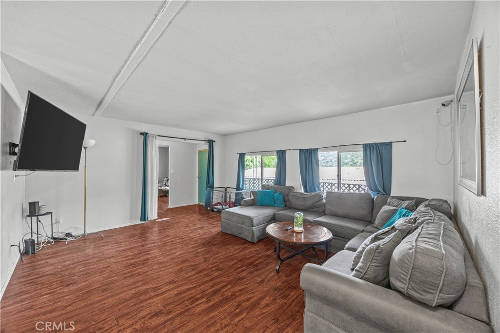 5700 Carbon Canyon Road, Unit 107 Brea, CA 92823 - Photo 1 of 27 a living room with furniture and a flat screen tv