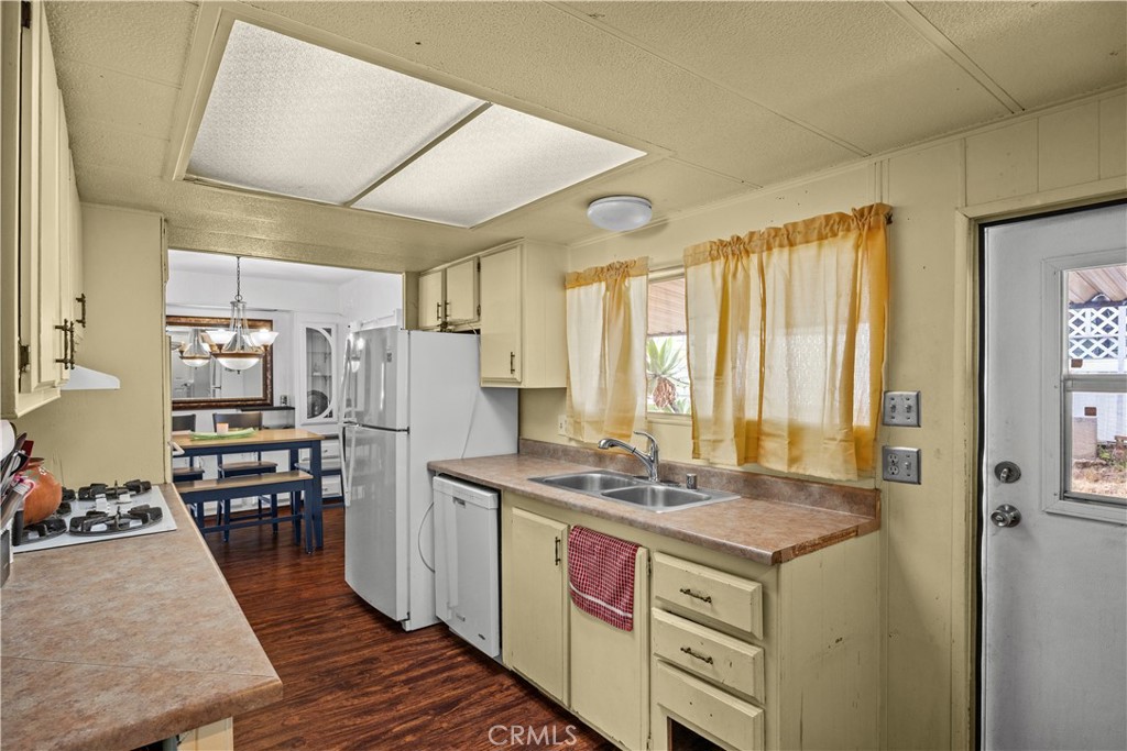 5700 Carbon Canyon Road, Unit 107 Brea, CA 92823 - Photo 13 of 27 a kitchen with stainless steel appliances granite countertop a stove and a refrigerator