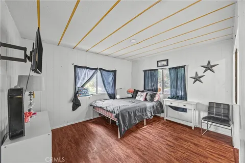 a living room with a bed furniture and a window