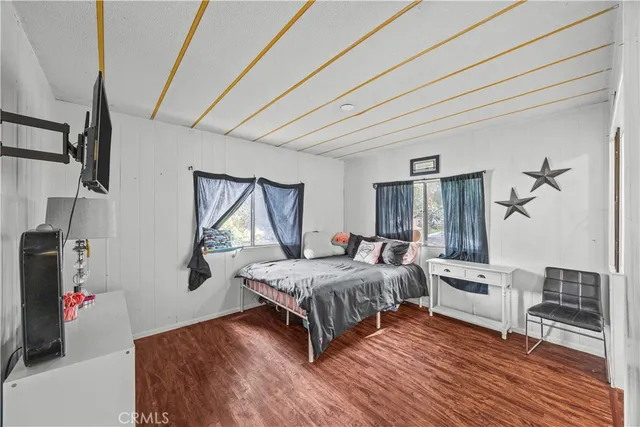 a living room with a bed furniture and a window