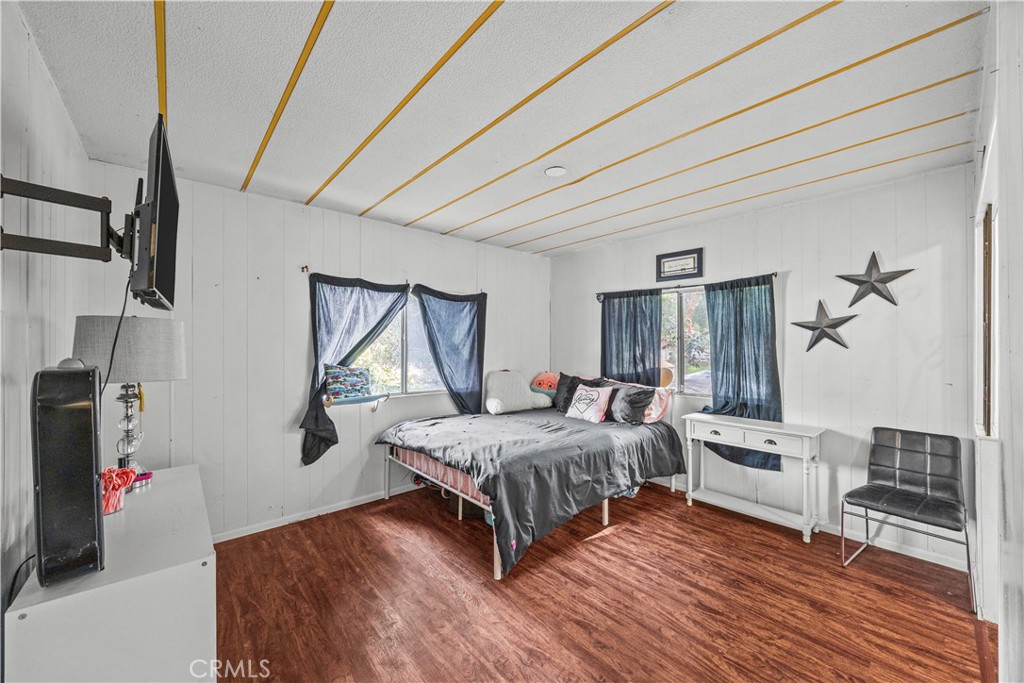 5700 Carbon Canyon Road, Unit 107 Brea, CA 92823 - Photo 15 of 27 a living room with a bed furniture and a window