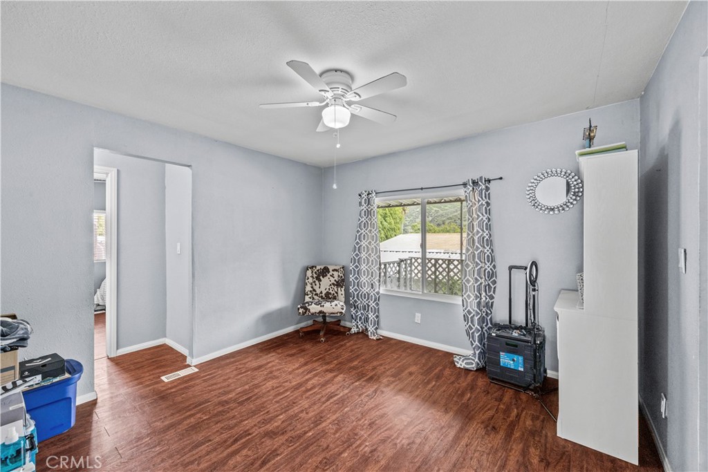 5700 Carbon Canyon Road, Unit 107 Brea, CA 92823 - Photo 19 of 27 a view of empty room with wooden floor and fan