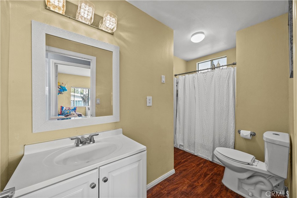 5700 Carbon Canyon Road, Unit 107 Brea, CA 92823 - Photo 23 of 27 a bathroom with a sink a toilet a mirror and shower