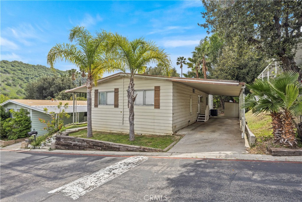 5700 Carbon Canyon Road, Unit 107 Brea, CA 92823 - Photo 24 of 27 a view of a house with a yard and floor to ceiling window