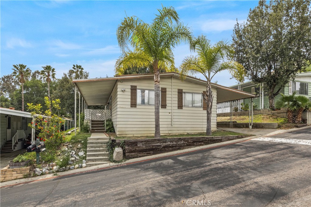 5700 Carbon Canyon Road, Unit 107 Brea, CA 92823 - Photo 4 of 27 a view of a house with a yard and potted plants