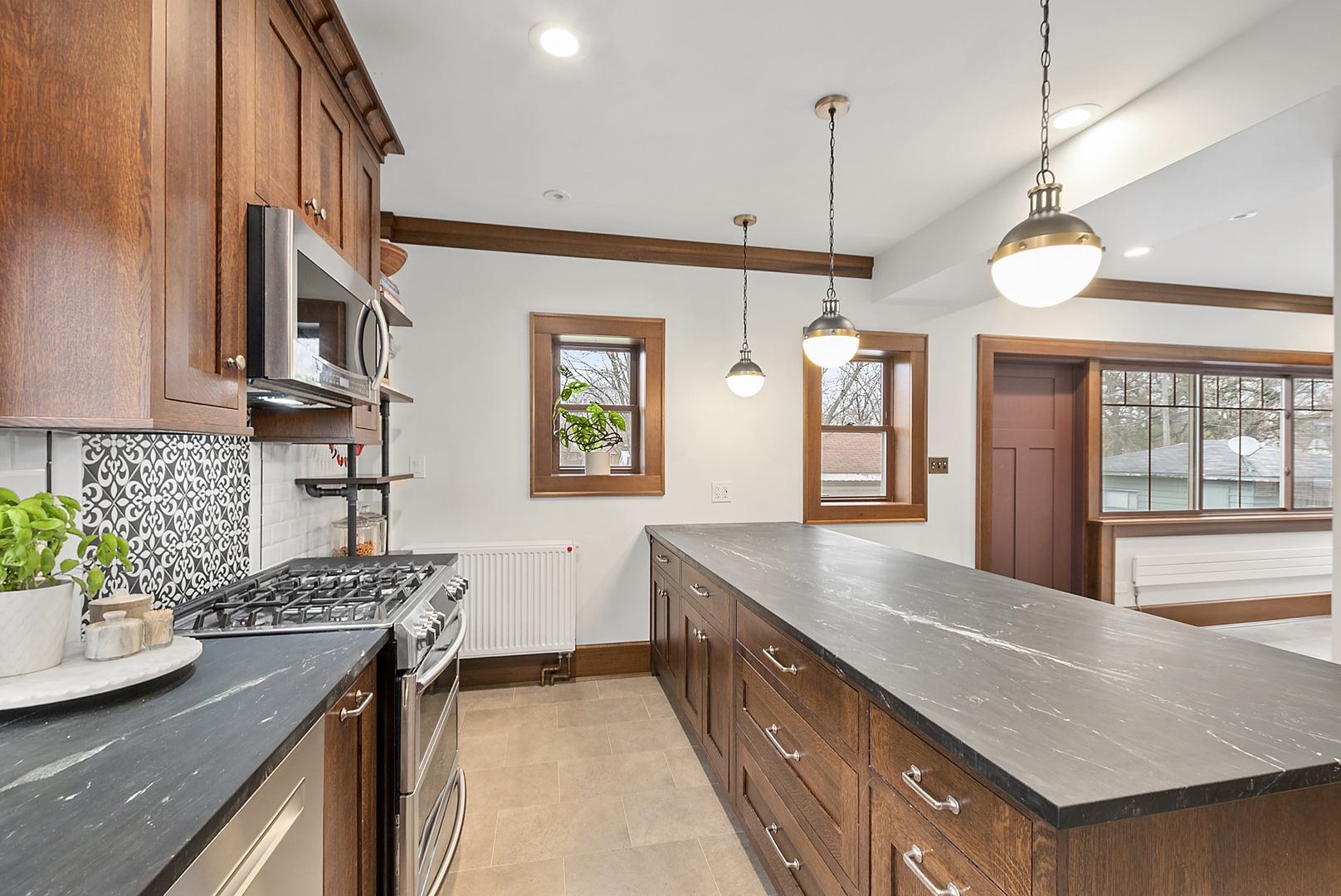 2138 West 109th Street Chicago, IL 60643 - Photo 13 of 33 a kitchen with stainless steel appliances granite countertop a sink a stove and a wooden floor
