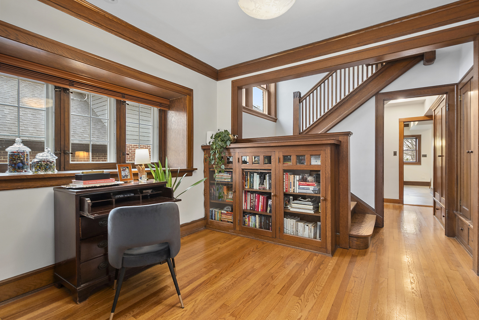 2138 West 109th Street Chicago, IL 60643 - Photo 3 of 33 a dining room with a wooden floor and a book shelf