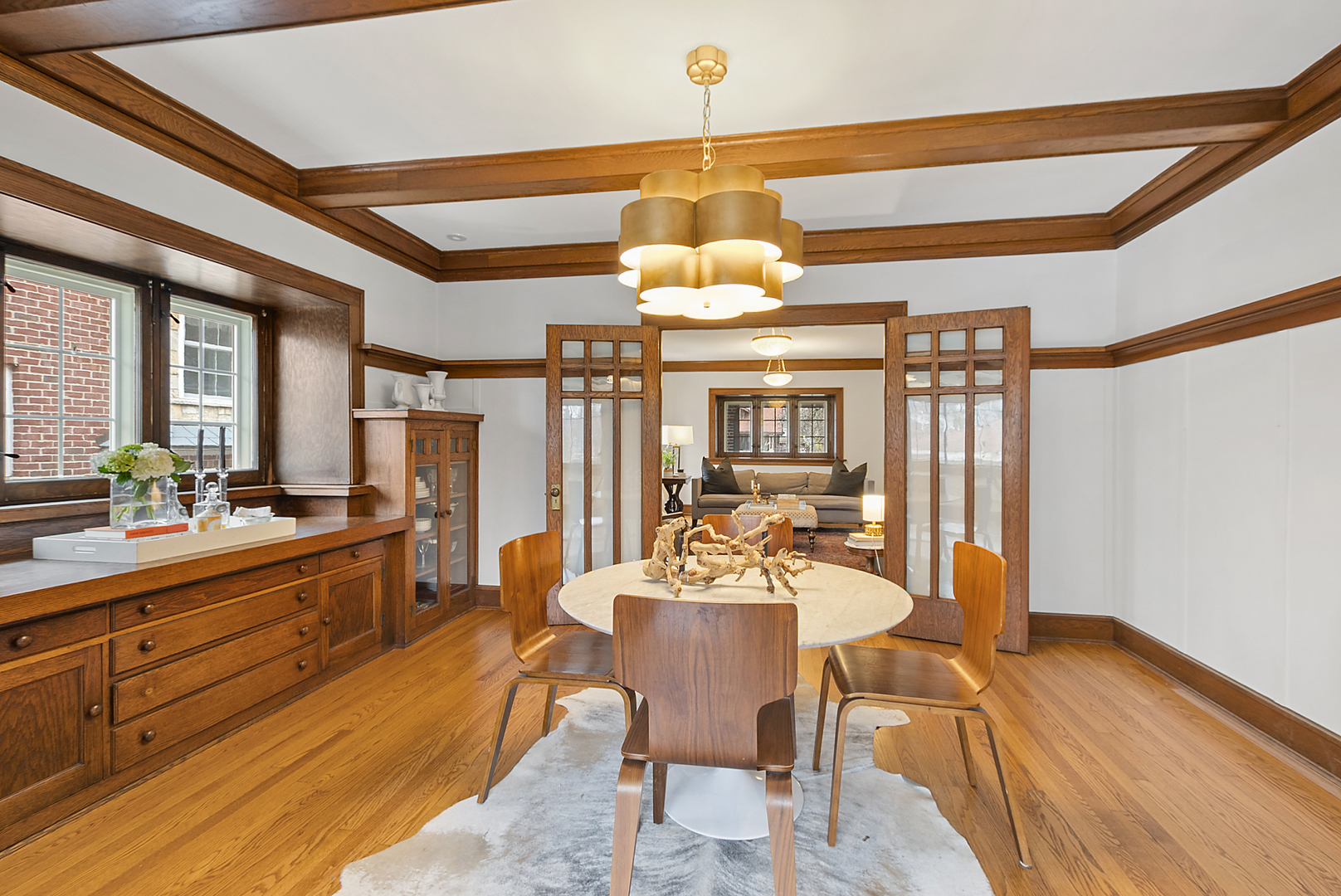 2138 West 109th Street Chicago, IL 60643 - Photo 9 of 33 a dining room with wooden floor a chandelier a wooden table and chairs