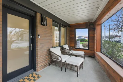 a balcony with furniture and large window