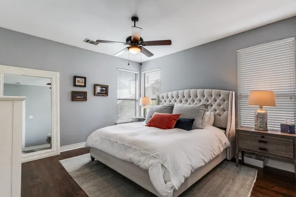 a bedroom with bed and a large window