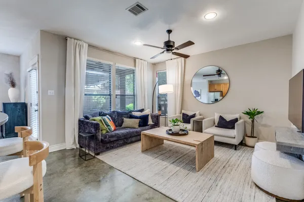 a living room with furniture and a large window