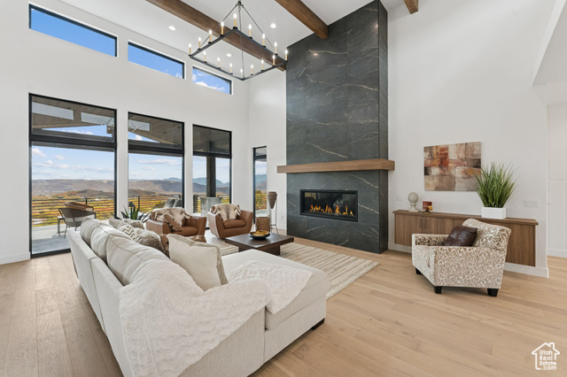 2280 East Outlaw Road, Unit 56 Kamas, UT 84036 - Photo 13 of 59 Living room featuring beam ceiling, a premium fireplace, light wood-type flooring, a high ceiling, and a mountain view