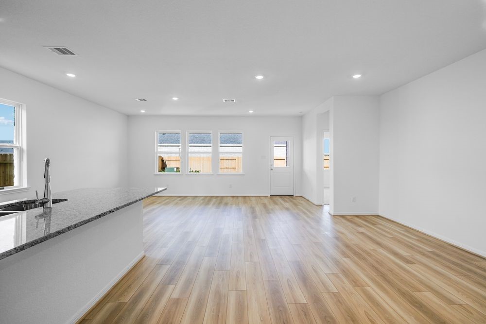 5606 Buttonbush Court Rosenberg, TX 77471 - Photo 15 of 34 an empty room with wooden floor and windows