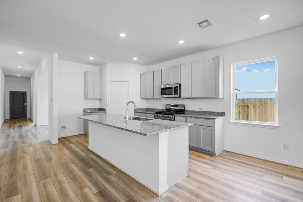 5606 Buttonbush Court Rosenberg, TX 77471 - Photo 3 of 34 a kitchen with stainless steel appliances granite countertop a stove a sink and a refrigerator