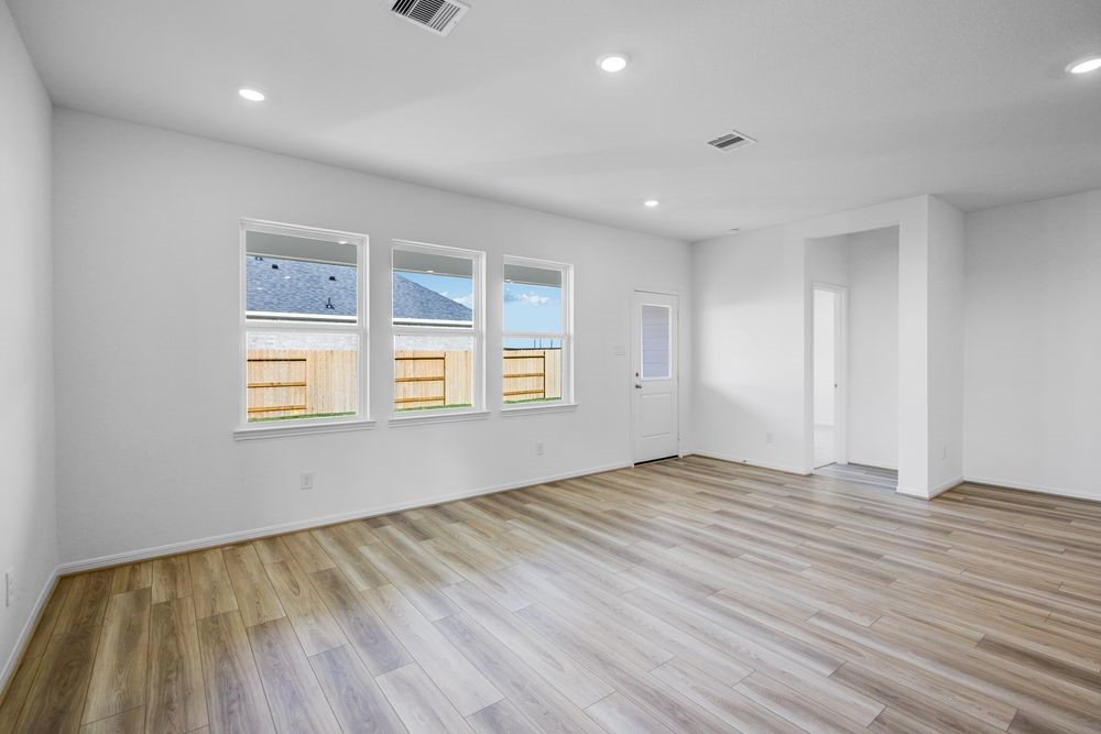 5606 Buttonbush Court Rosenberg, TX 77471 - Photo 6 of 34 a view of an empty room with wooden floor and a window