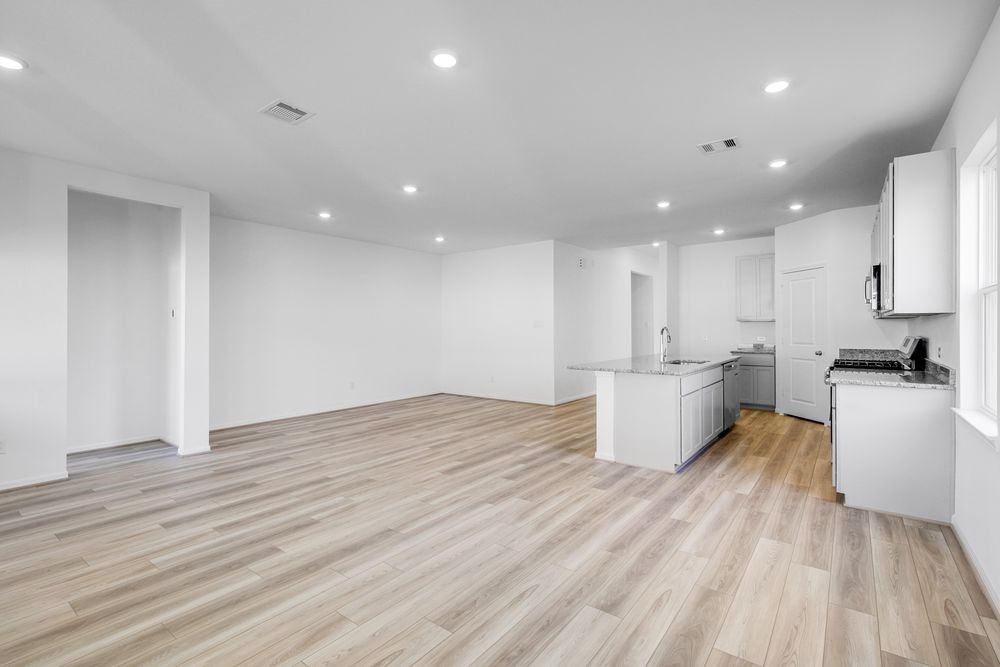 5606 Buttonbush Court Rosenberg, TX 77471 - Photo 8 of 34 a large white kitchen with wooden floor and stainless steel appliances