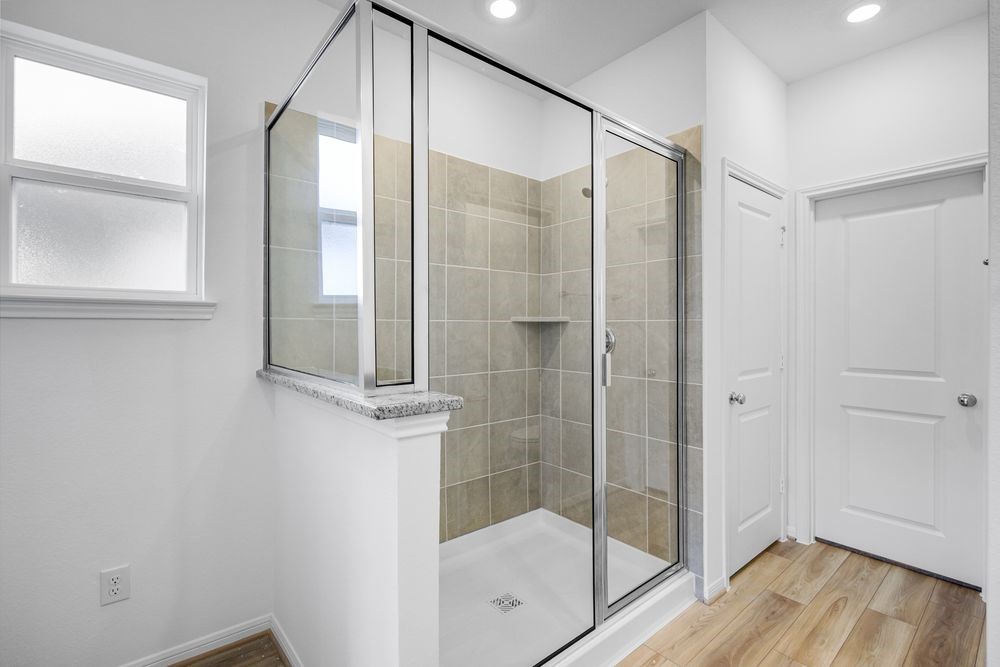 5606 Buttonbush Court Rosenberg, TX 77471 - Photo 9 of 34 a bathroom with a glass shower door