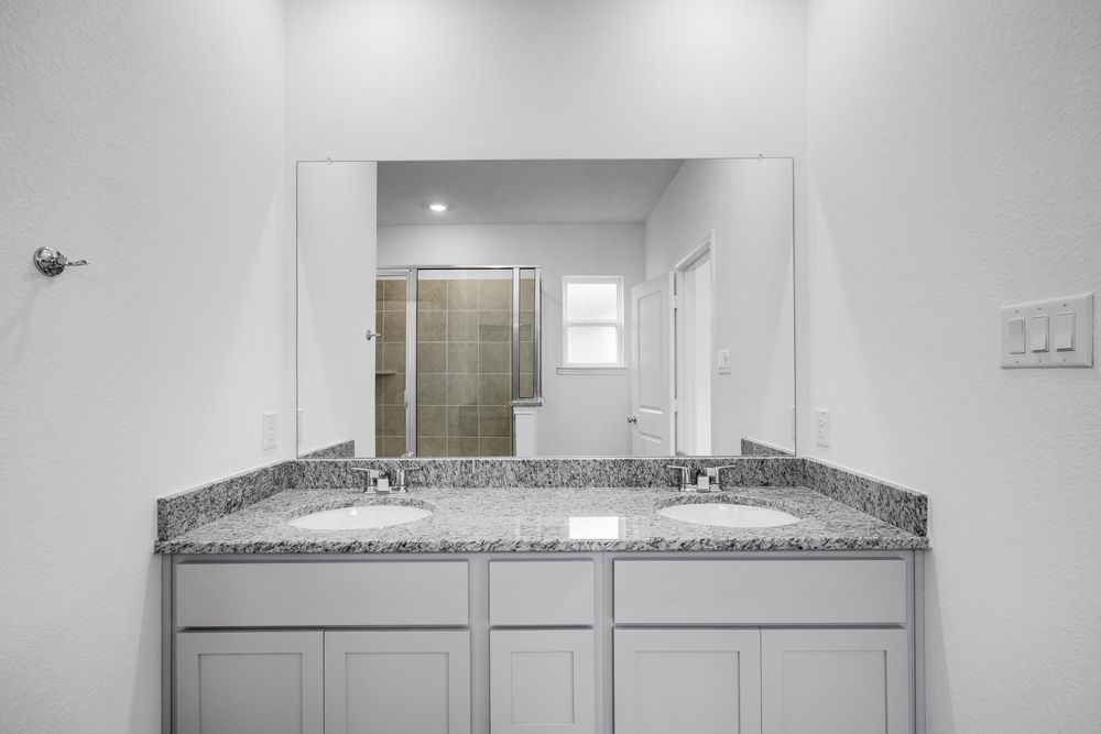 5606 Buttonbush Court Rosenberg, TX 77471 - Photo 10 of 34 a bathroom with a granite countertop sink and a mirror