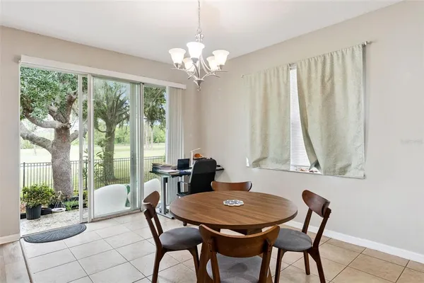 a kitchen with a stove a table and chairs