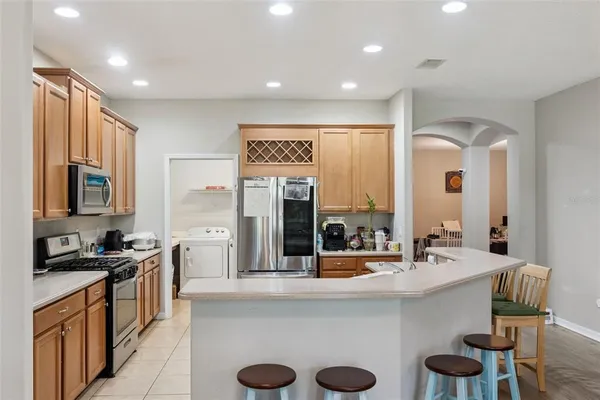 a kitchen with stainless steel appliances granite countertop a refrigerator and a stove top oven