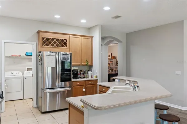 a kitchen with stainless steel appliances granite countertop a refrigerator and a stove top oven