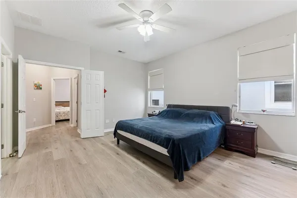 a bedroom with a bed and a book shelf