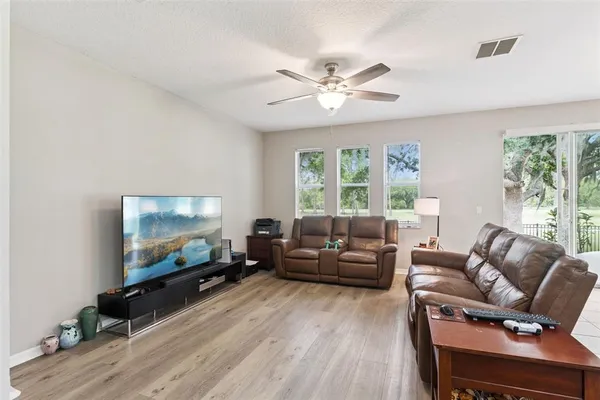 a living room with furniture and kitchen view