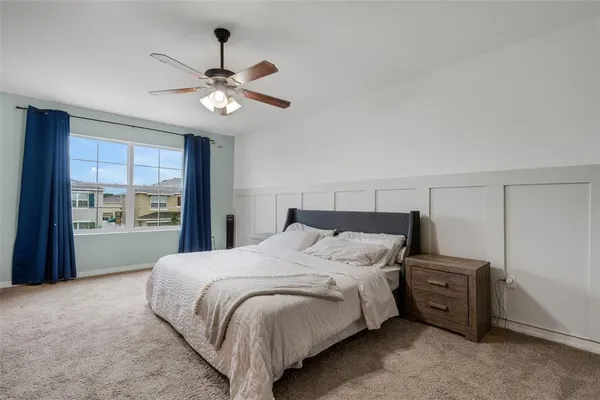 a bedroom with a bed and a chandelier