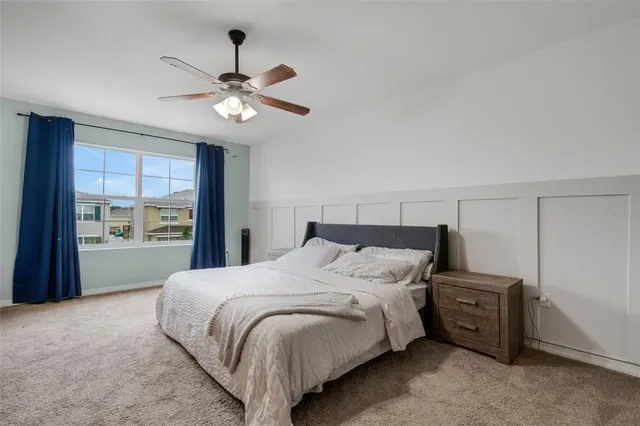 a bedroom with a bed and a chandelier