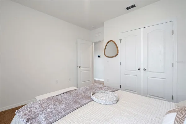a bedroom with a bed and cabinets
