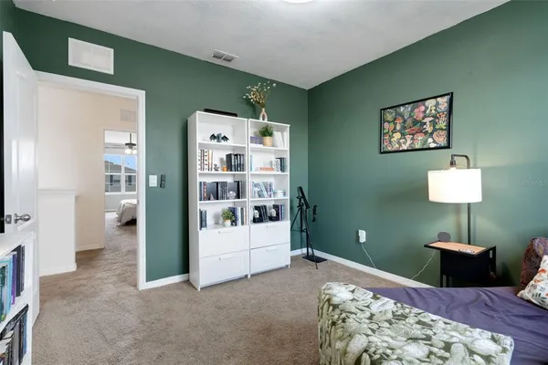 a bedroom with furniture and a rug